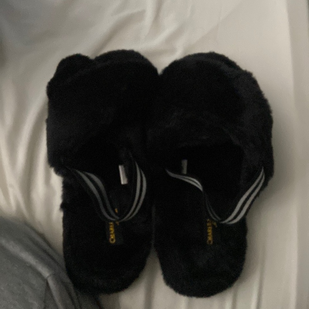 I’m selling fuzzy black slippers.